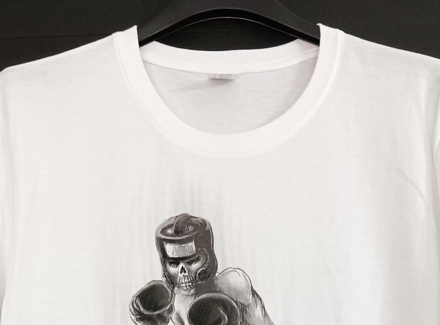 White T-shirt featuring a black-and-white illustration of a skeletal boxer in the ring, wearing gloves and a headguard, finished by hand