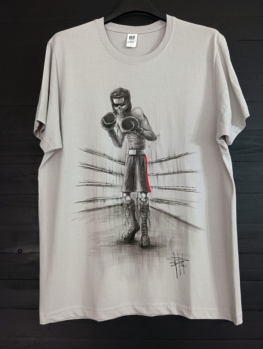 A light grey T-shirt featuring a black-and-white illustration of a skeletal boxer in the ring, wearing gloves and a helmet, finished by hand