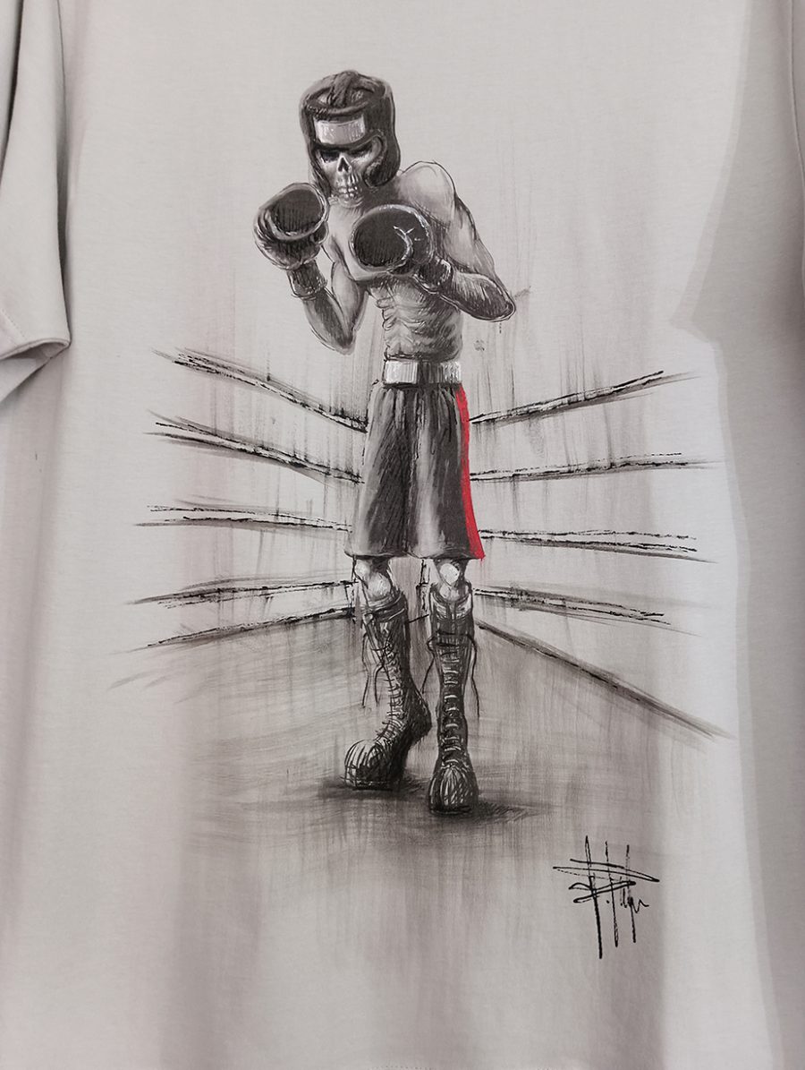 A light grey T-shirt featuring a black-and-white illustration of a skeletal boxer in the ring, wearing gloves and a helmet, finished by hand